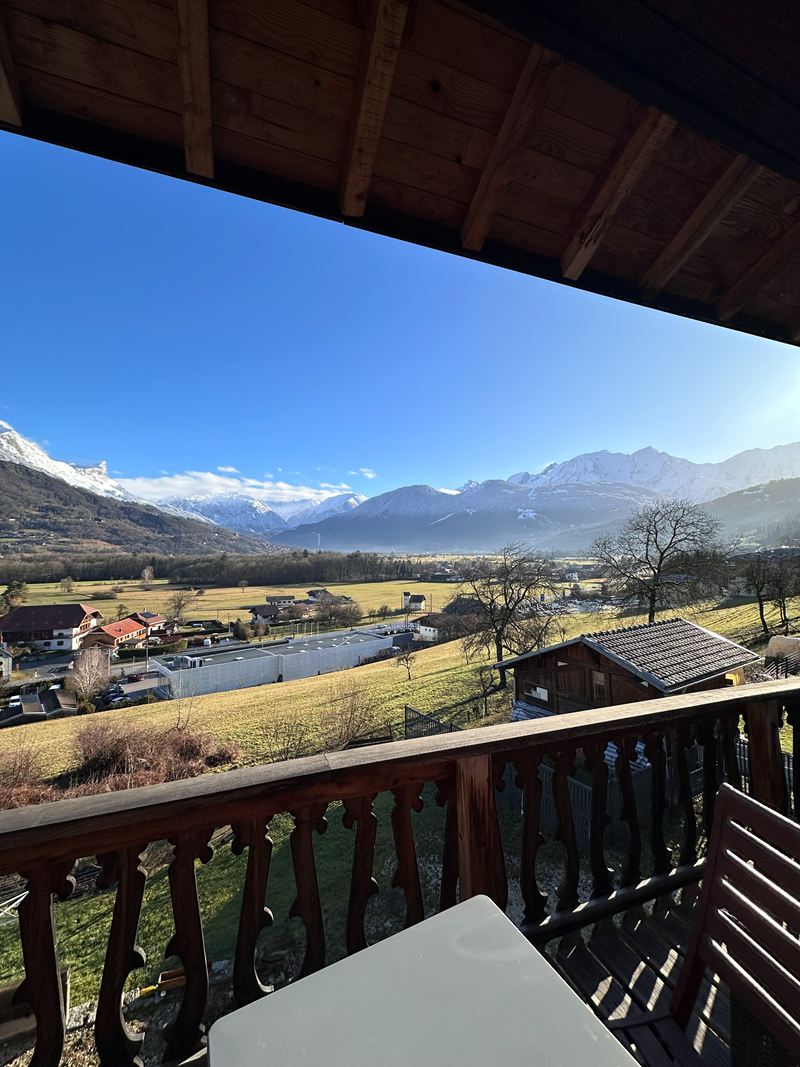 Mountain views from a chalet balcony on a sunny day