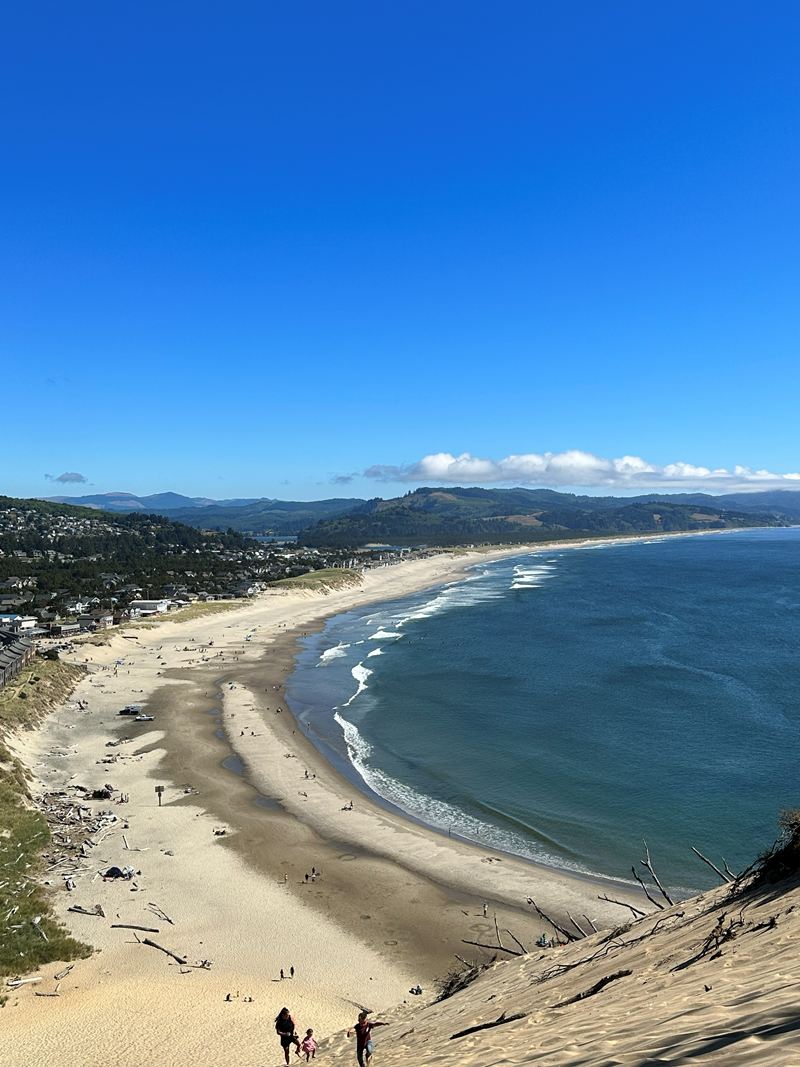 A sandy beach curving along a bay