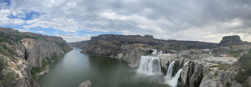Panorama of a wide waterfall in a canyon