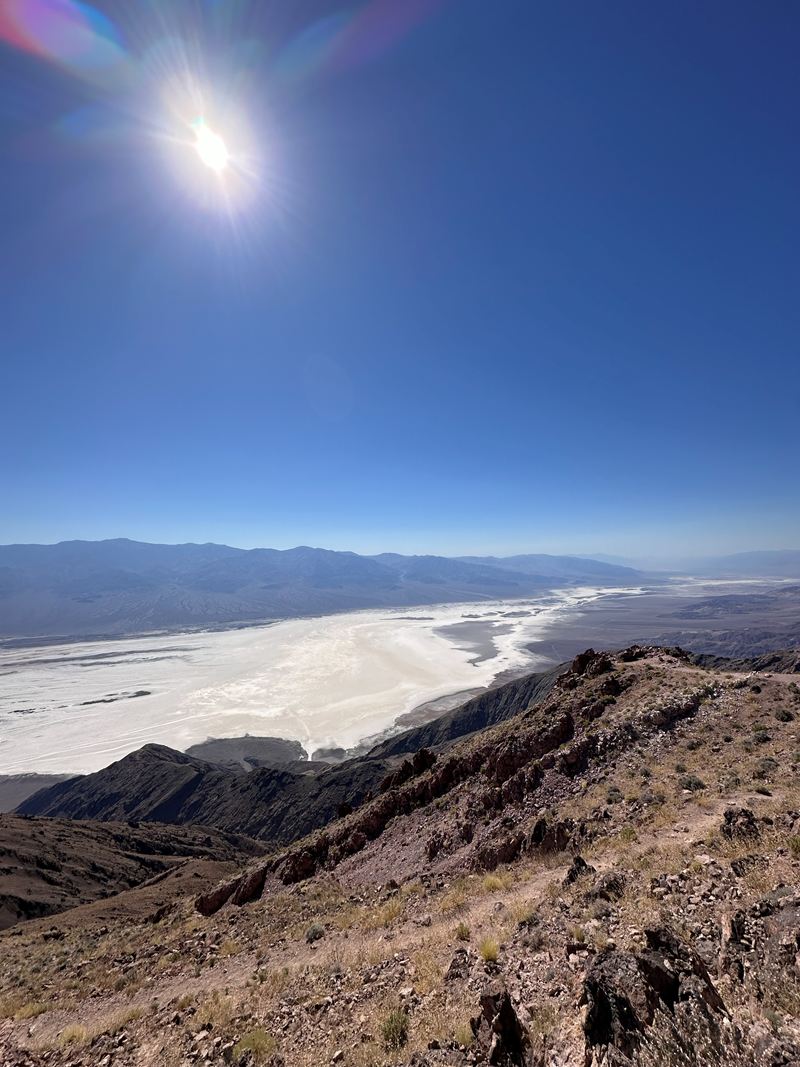 A desert valley with a bright salt flat, seen from a ridge