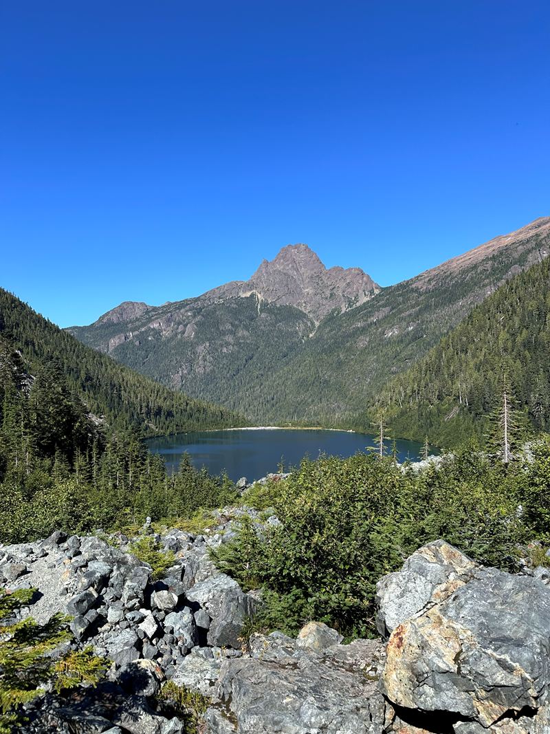 An alpine lake below a rocky mountain peak